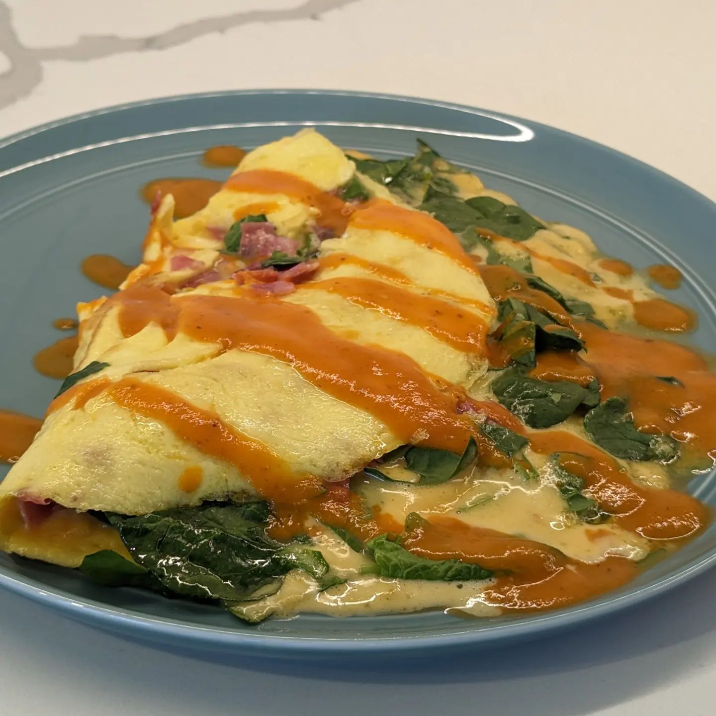 Omelettes are maybe the ultimate keto meal.Super filling, great macros, quick to make, and so tasty!This one was loaded with chopped spinach, cheddar cheese, salami, hollandaise (gotta love leftovers) and topped with some habanero hot sauce. #omellete #breakfast #lunch #ketomeal #easymeal #foodinspiration
