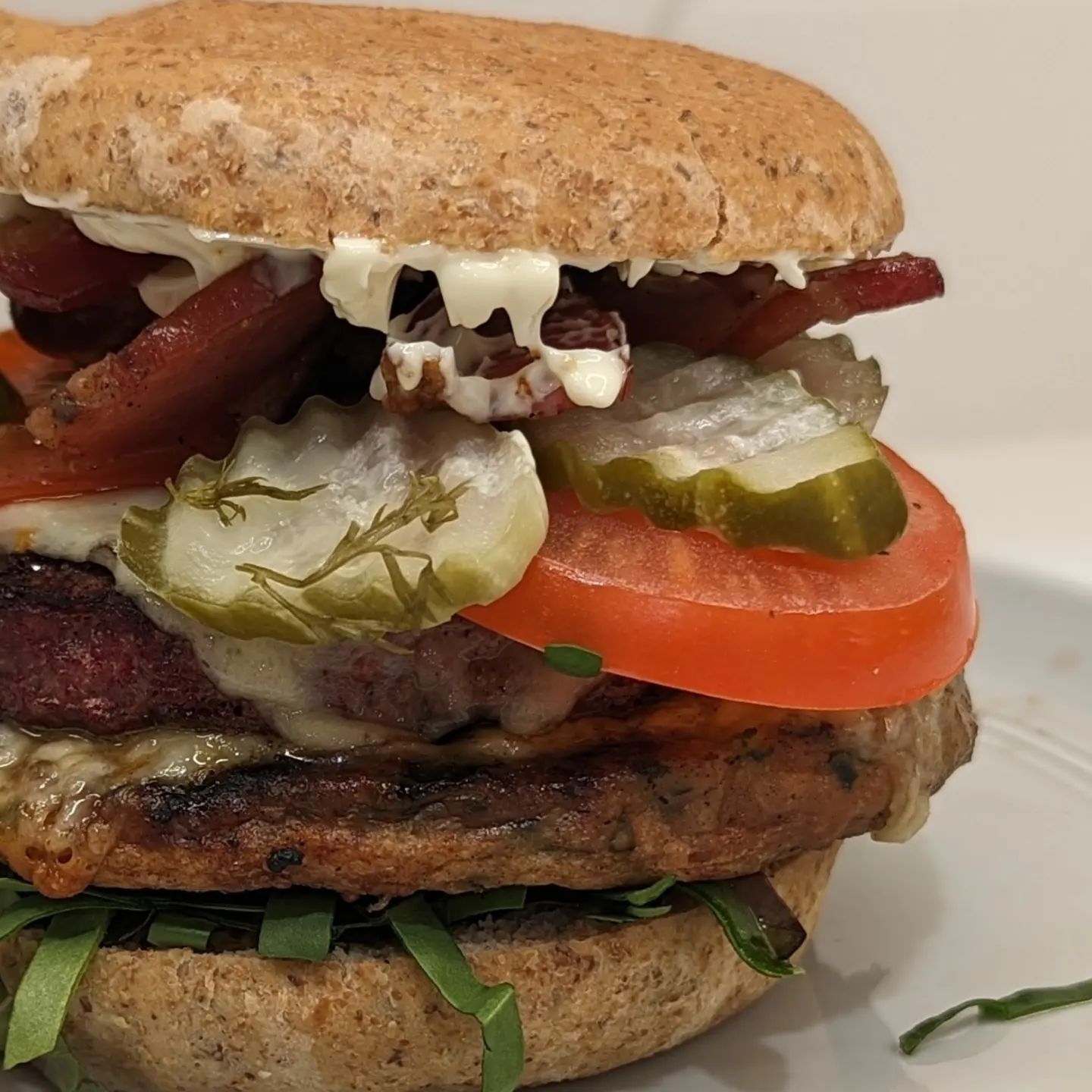 Burgers always hit the spotThis loaded burger was delicious. One @butcher_box beef patty and one @amylufoods patty. Grilled in the Yoder using @bearmountainbbq apple wood pellets. While they grilled down below, I had the bacon up top dripping over the burgers. Lettuce, tomato, @grillospickles pickles and a bit of mayo added some freshness and ghost pepper jack cheese rounded out all the fillings. Sandwiched between @carbonautbaking buns and I was set! #burger #cheeseburger #baconcheeseburger #grilling #hamburger #lowcarb