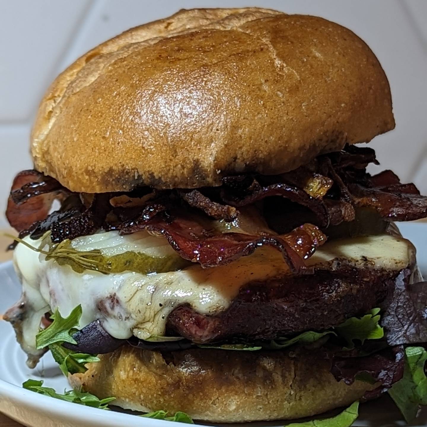 Bacon cheeseburger to get back on trackI was away on work travel the last week, and ate wildly off track from my normal day to day. This burger was a lovely transition back to normal.A @hero bun kept it low carb, though a helping of caramelized onions did up the carbs a bit, it was still within the plan for the day. A few strips of bacon, some pepper jack cheese, @grillospickles and lettuce rounded out the toppings with @terrapinridgefarms everything sauce being the only condiment I needed. The burger and bacon were both cooked using @bearmountainbbq hickory pellets, directly over the fire in my @yodersmokers at 375.#cheeseburger #hamburger #baconcheeseburger #caramelizedonions #lowcarb #backontrack #burgergoals