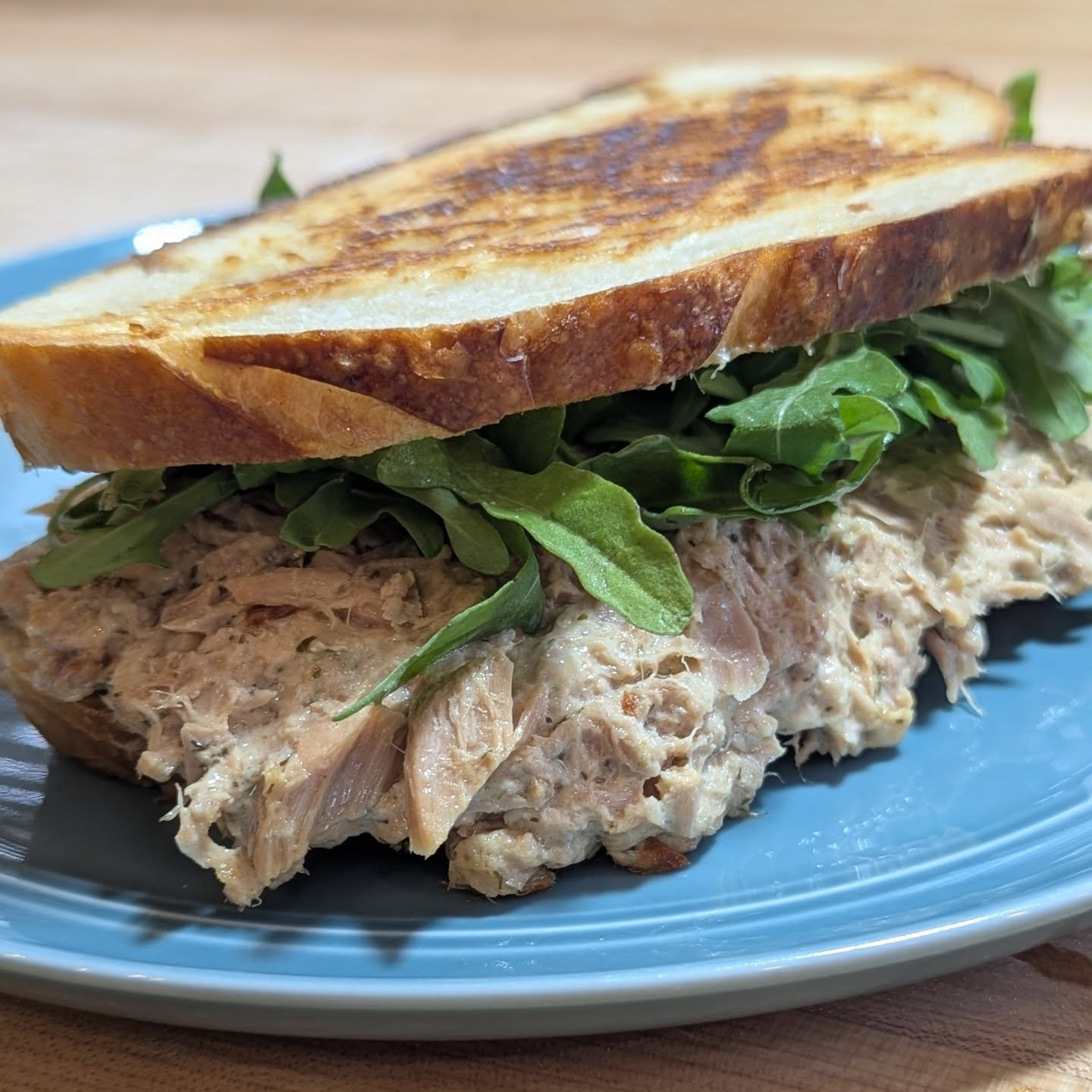 Protein packed Tuna Melt. Two cans of @starkistcharlie tuna mixed with just a touch of mayo loaded into some fresh sourdough and two slices of @cabotcreamery seriously sharp cheddar. Cooked over medium low heat on a griddle with some Cabot butter. Once golden brown and warm through I pulled back one side and tossed in a bit of arugula. This was an absolutely delightful lunch.