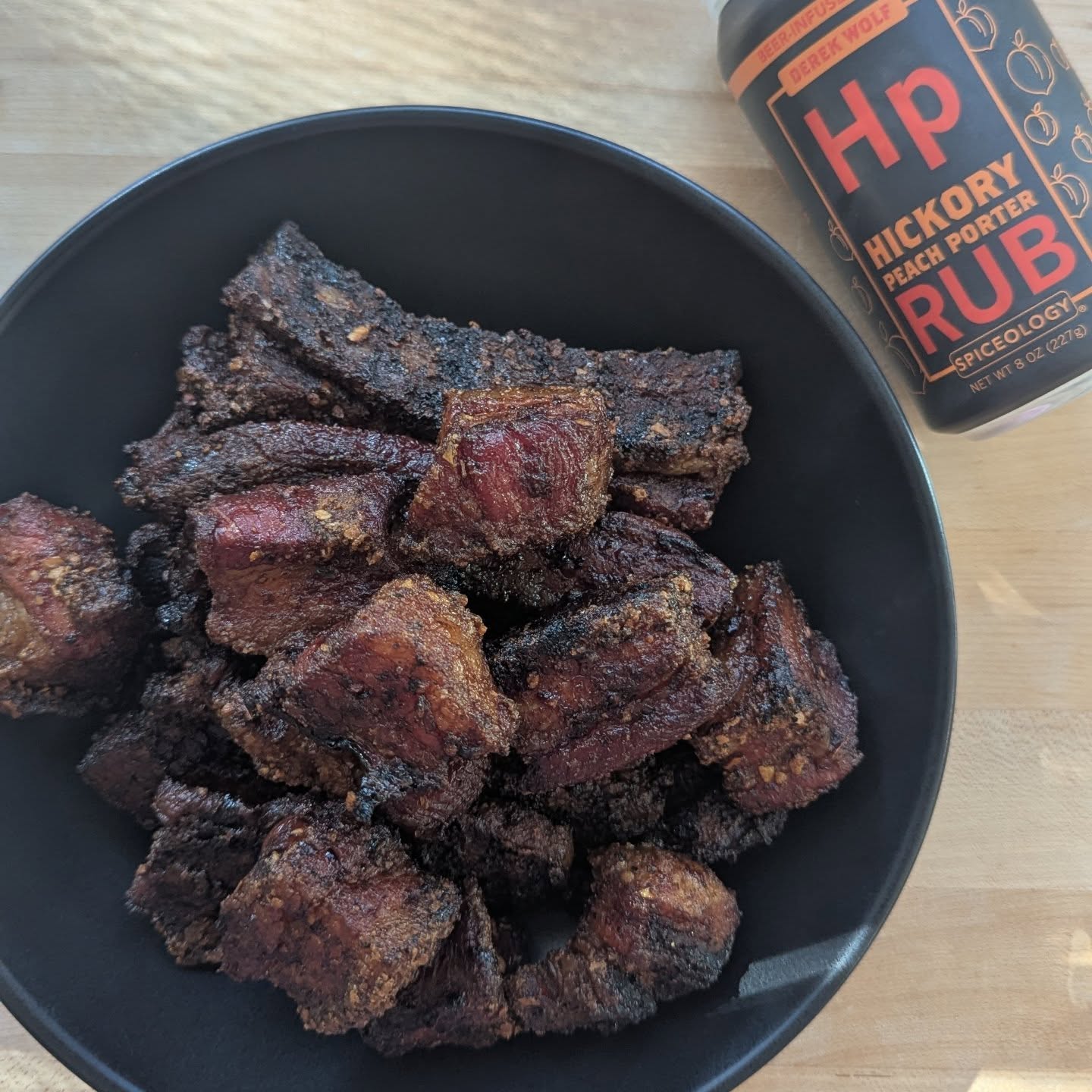 Pork belly magic! When your friends invite you to a tailgate, pork belly and pork belly sliders will always be a winner. This pork belly was sliced into slabs and tossed in @spiceology hickory peach Porter rub. With the smoker preheated to 225, the pork belly was smoked with @bearmountainbbq cherry wood pellets for about 4 hours, giving it a deep and rich color and lovely smokey flavor. The thinner slabs were almost a pork jerky, with thicker ones falling into that pork belly burnt ends territory. After 4 hours they were tossed in a disposable tray with some butter and covered, cooking another hour. This made transport to the game easy, and the pork arrived ready to eat right out of the tray. #porkbelly #bearmountainbbq #spiceology #tailgate #pregame #foodwithfriends