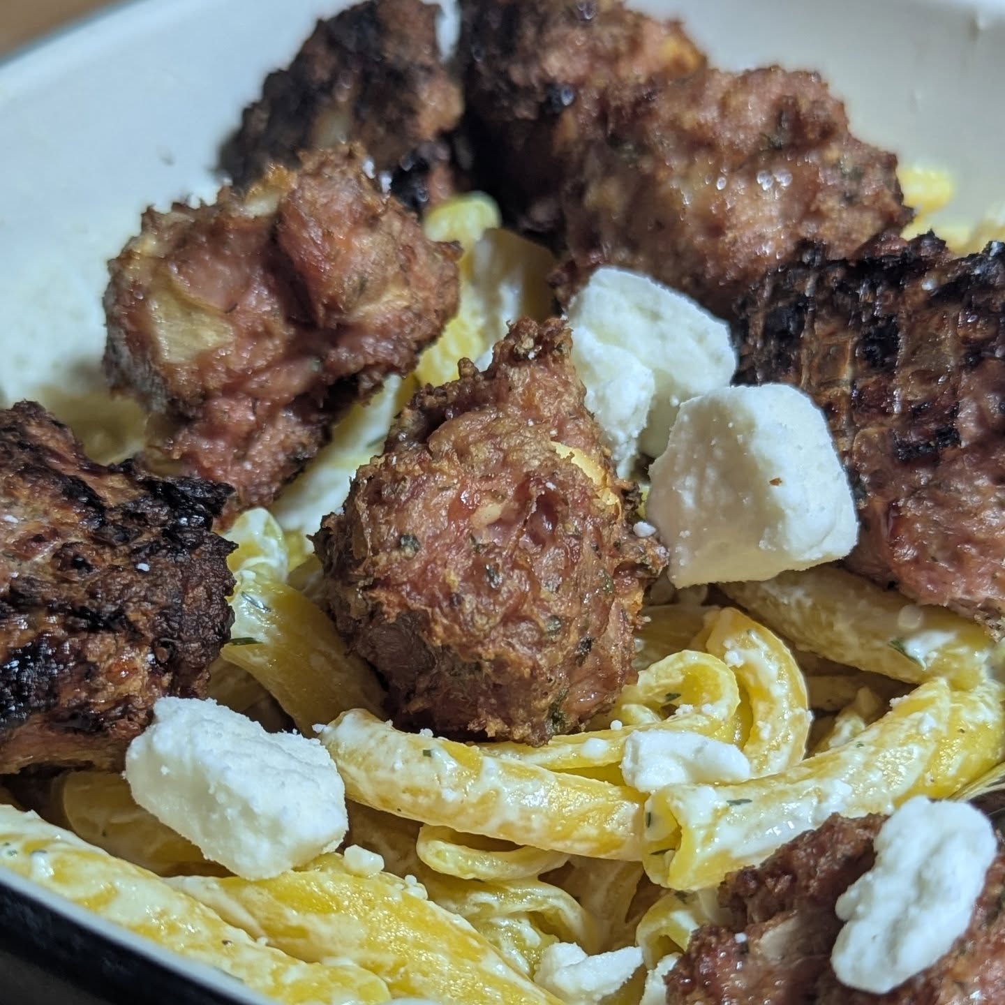 Mediterranean style turkey meatballs over lemon pasta. Smoked the turkey meatballs using @bearmountainbbq cherry wood pellets for a light smoke with bold color impact on the meatballs. The lemon pasta was tossed in tzatziki sauce. With a garnish of some more feta cheese. For a side, artichoke steamed with a shallot and herb seasoning. Everything came together really well. Was absolutely delicious and full of flavor. The smoked meatballs were the star, really elevated by the bright lemon flavor in the pasta. #turkeymeatballs #lemonpasta #artichoke #bearmountainbbq #smokedturkey