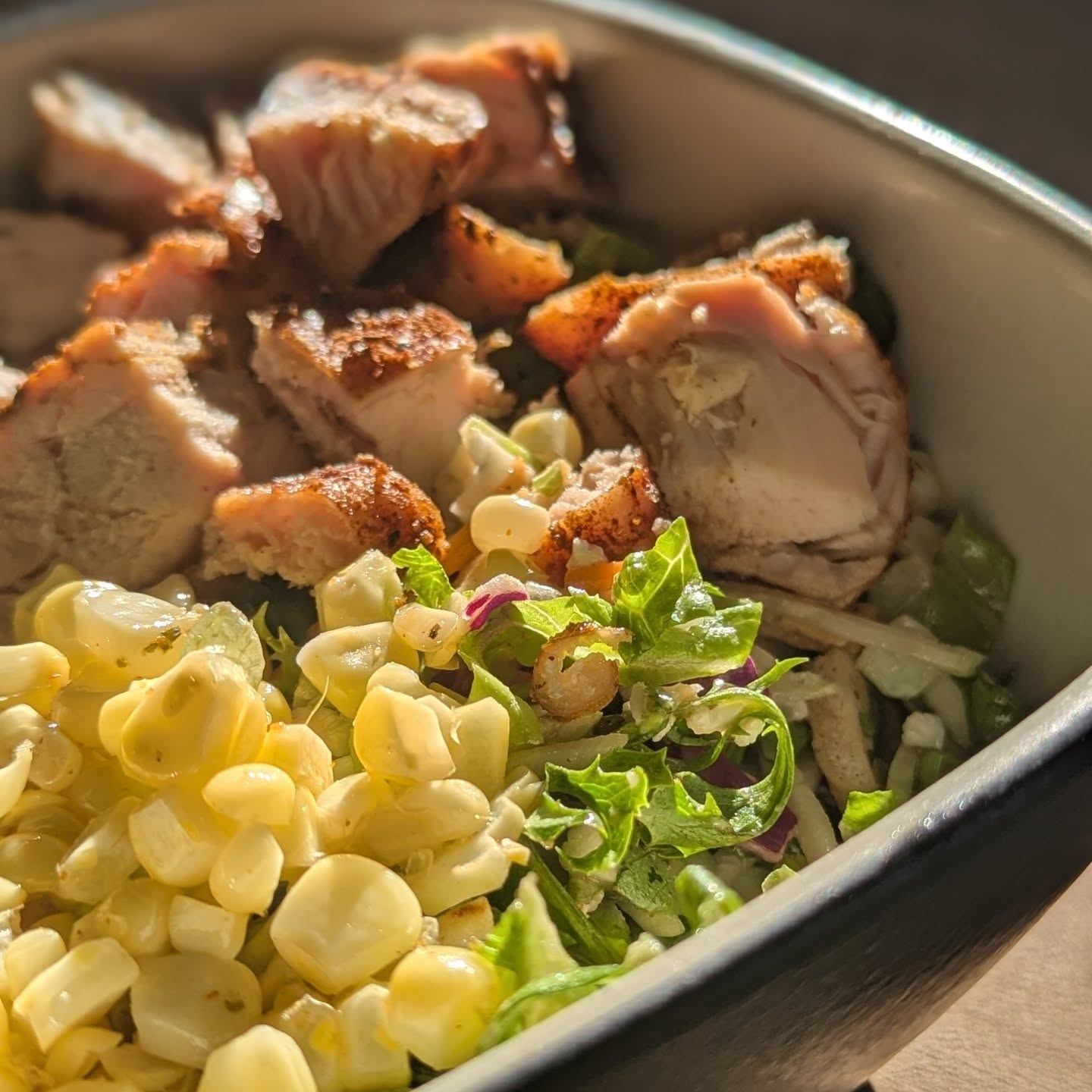 Mediterranean salad with smoked chicken breast and grilled corn. Using a premade salad kit served as an amazing base for this dinner. I seasoned some chicken breast in @neilsarap Mediterranean rub and let it get a nice smoke bath with @bearmountainbbq cherry wood at 200 degrees for about an hour, then I bumped the temp to 375 to finish. The corn was coated in butter and @spanglishasadero_official elote seasoning, foil wrapped and cooked with the chicken on the grill. I mixed together the salad kit and topped it with the chicken breast and corn for a very easy and healthy dinner. #salads #saladkit #grilledchicken #bearmountainbbq #cherrywood #smokedchicken #healthyhabits