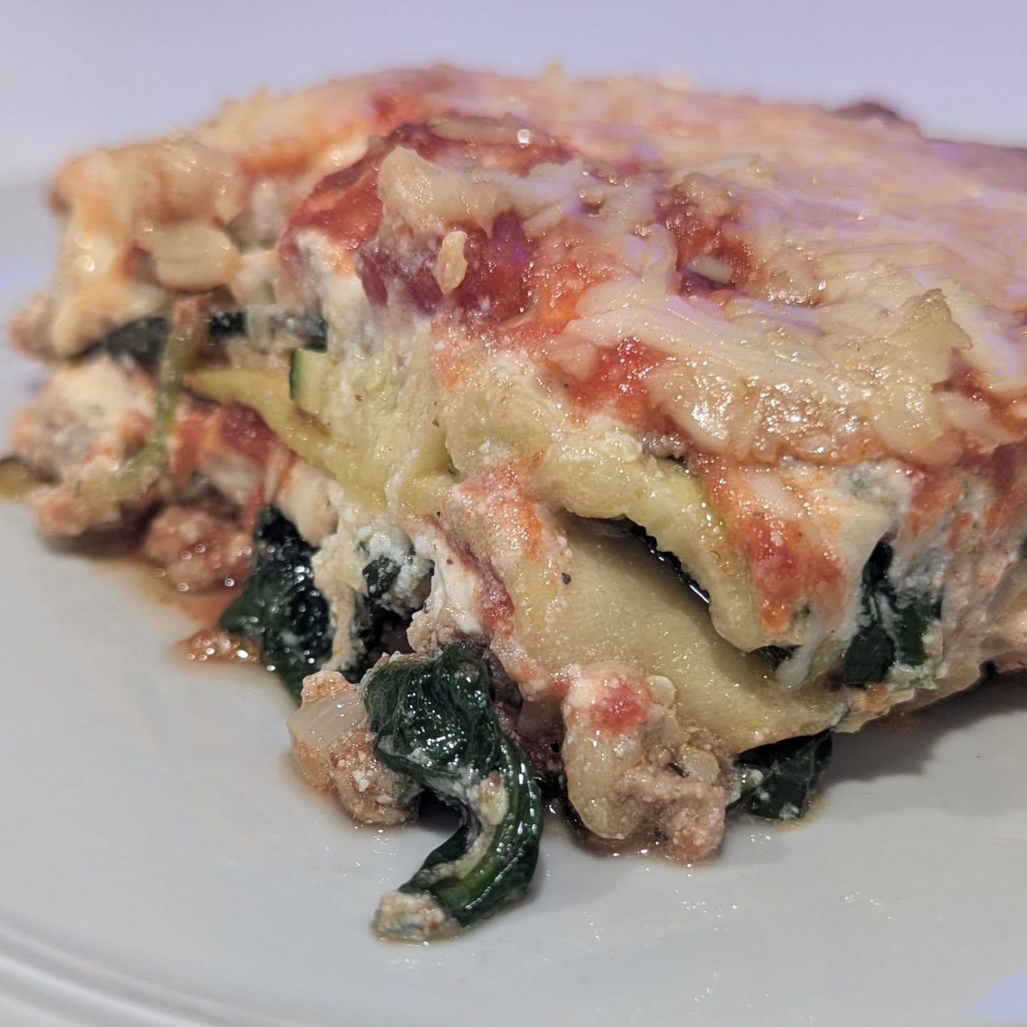 Smoked zucchini lasagna This is an amazing meal to prepare in advance and have as an easy lunch or dinner throughout the week. Replacing the noodles with zucchini keeps the carb level down. I use ground turkey as my high protein low fat meat and add spinach for some extra greens. The cream cheese, sour cream and ricotta and mozzarella make up the cheese component within the lasagna. I also layer in some marinara and top with loads of mozzarella and parmesan. Everything was seasoned with @spiceology pizza seasoning for this batch.Cooking this in the smoker gives it a really lovely smokey flavor that only gets better the next day. For this batch I went with the @bearmountainbbq gourmet blend and found the smoke to be just right. #lasagna #zuchinni #zuchinnilasagna #bearmountainbbq #lowcarb #healthyfoods