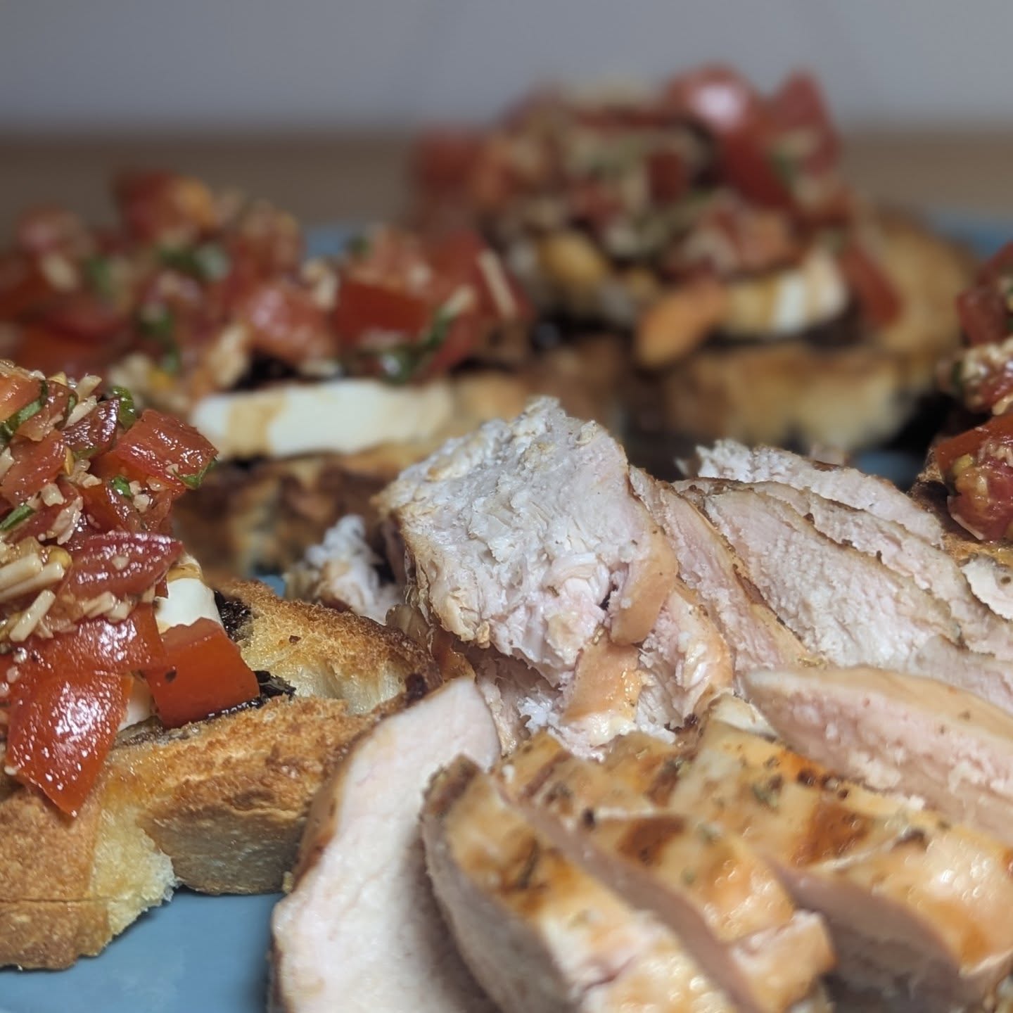 Bruschetta and smoked chicken breast Sourdough toast topped with fresh mozzarella, habanero balsamic drizzle and a mix of diced tomatoes, garlic, parmesan, balsamic, olive oil, basil, salt and pepper. Served up with chicken breast that was smoked with @bearmountainbbq gourmet blend. I started the grill at 350 to hear the grill grates then dropped the temp to 225 for a nice smoke to pair with the bruschetta. The result is a beautiful smokey chicken breast. #bruschetta #smokedchicken #bearmountainbbq #dinnerinspiration